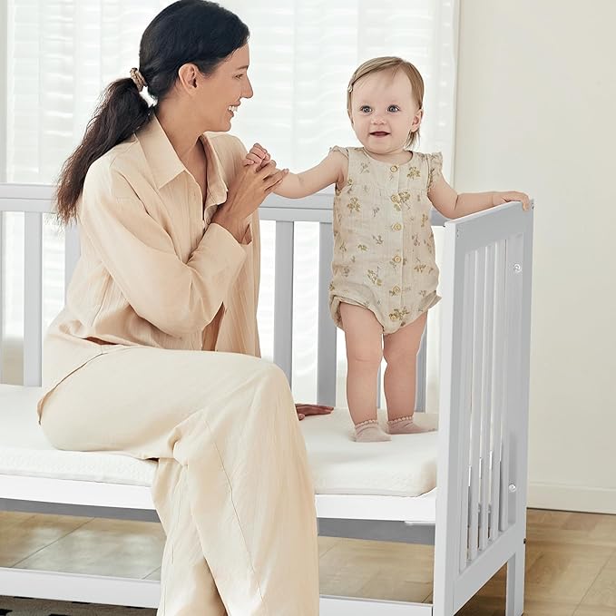 EvoNest Baby Crib, 6 in 1 Convertible Mini Crib with Wheels, 100% New Zealand Solid Wood Growing Bed, 4 Adjustable Mattress Height,White